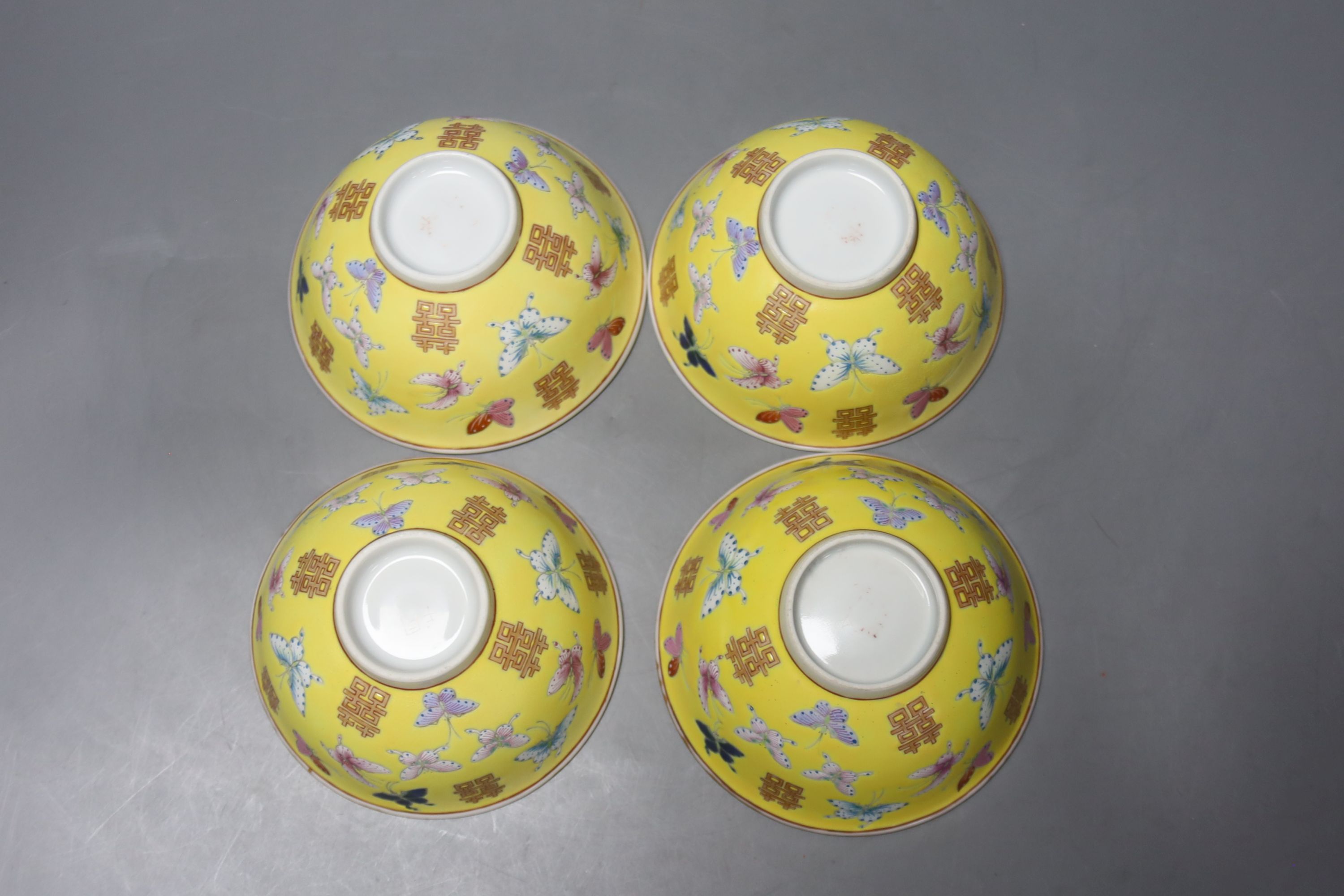 A set of four Chinese yellow ground rice bowls, diameter 11cm